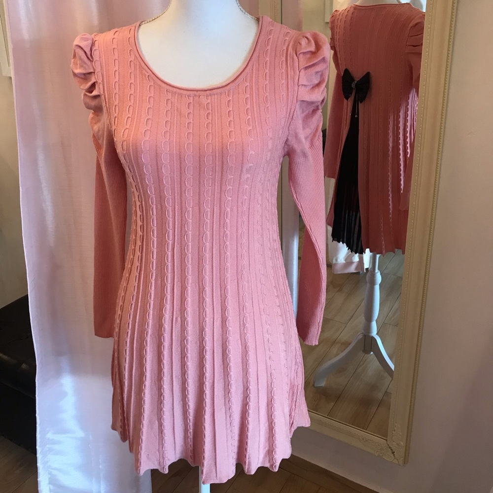 Pink dress with bow and pleats in the back.